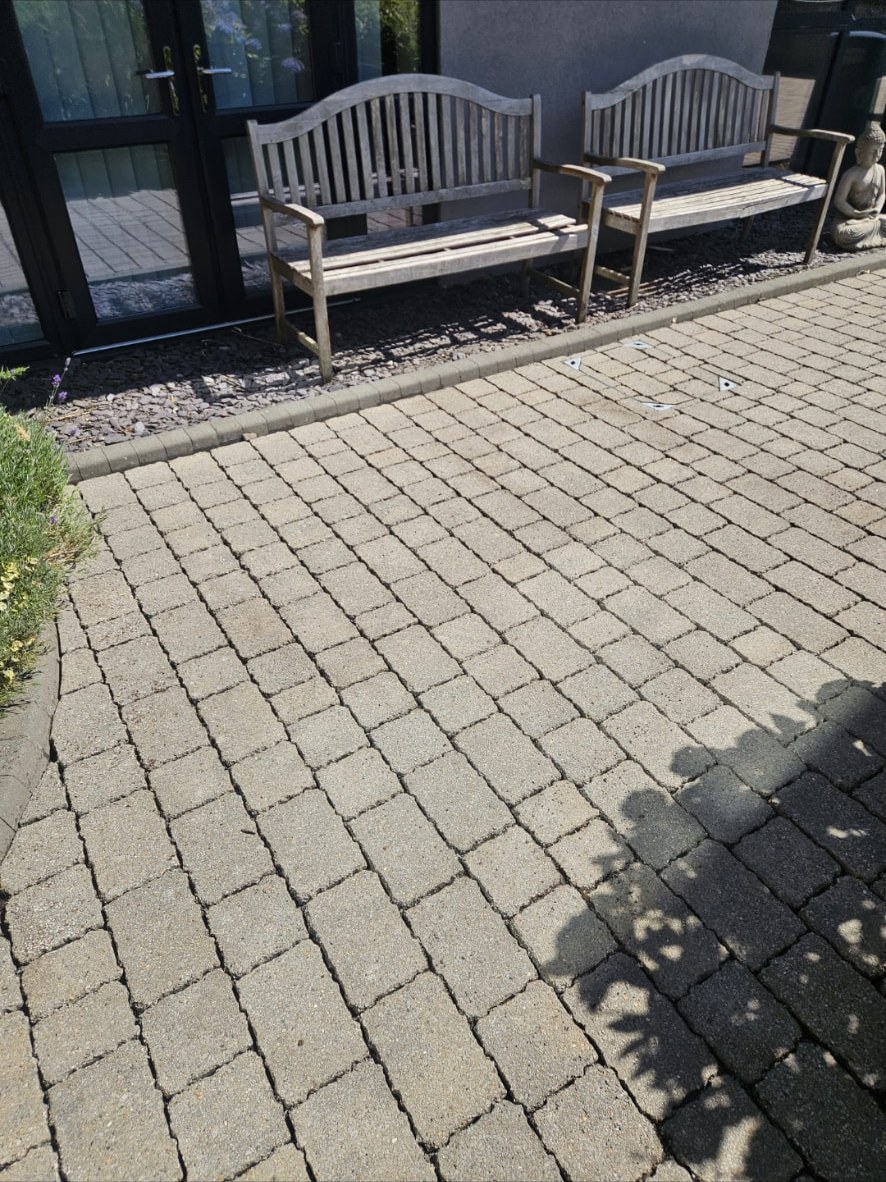 Clean block paving in front of commercial seating after pressure washing